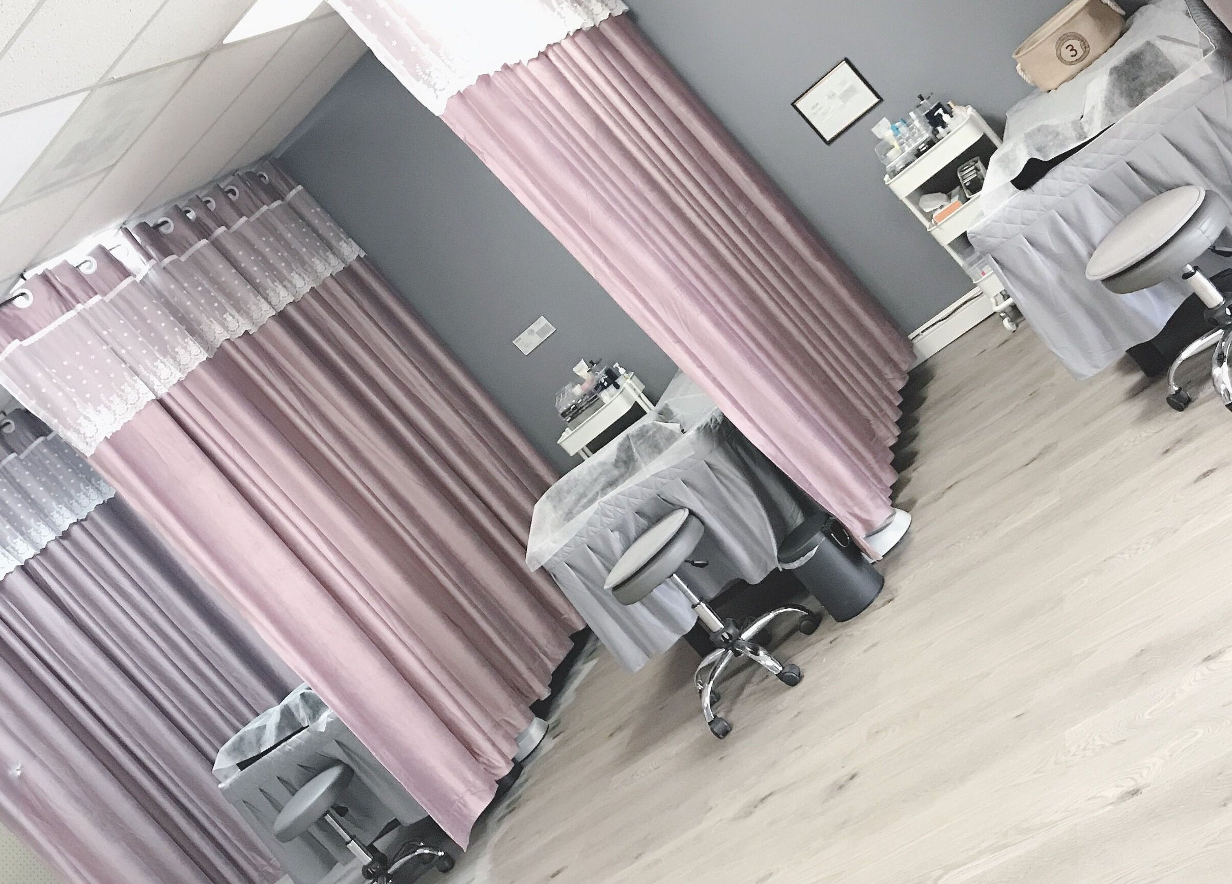 Peaceful treatment room at J.S beauty zone, Covina, California, US with pink curtains and spa chairs.