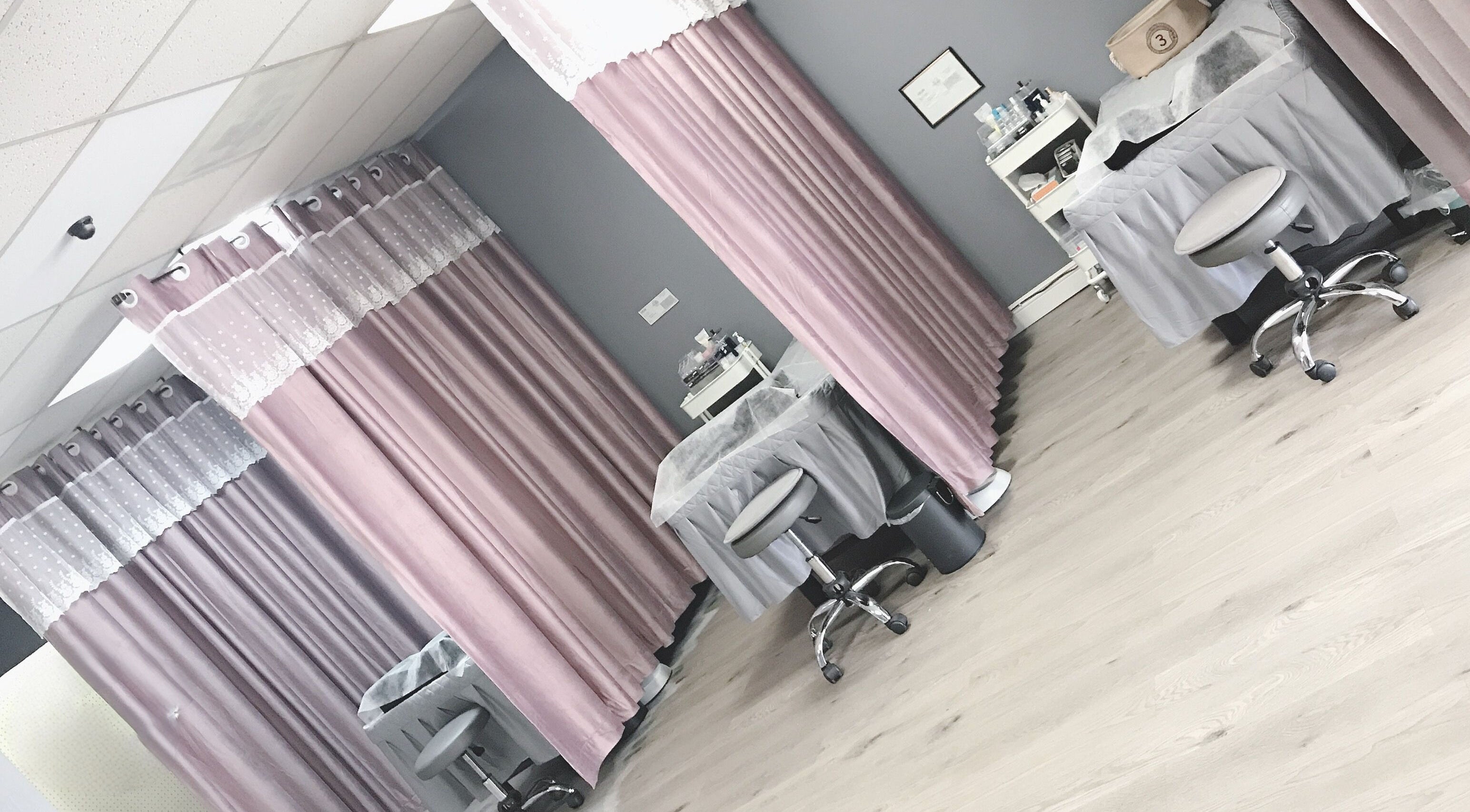Peaceful treatment room at J.S beauty zone, Covina, California, US with pink curtains and spa chairs.