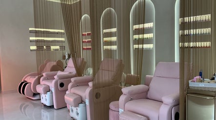 Luxurious seating at Pink Plastic Women Salon Business Bay, Dubai, Dubai, AE, surrounded by nail polish displays.