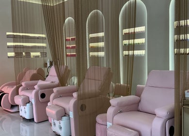 Relaxing lounge at Pink Plastic Women Salon Business Bay, Dubai, Dubai, AE with plush pink chairs and elegant decor.