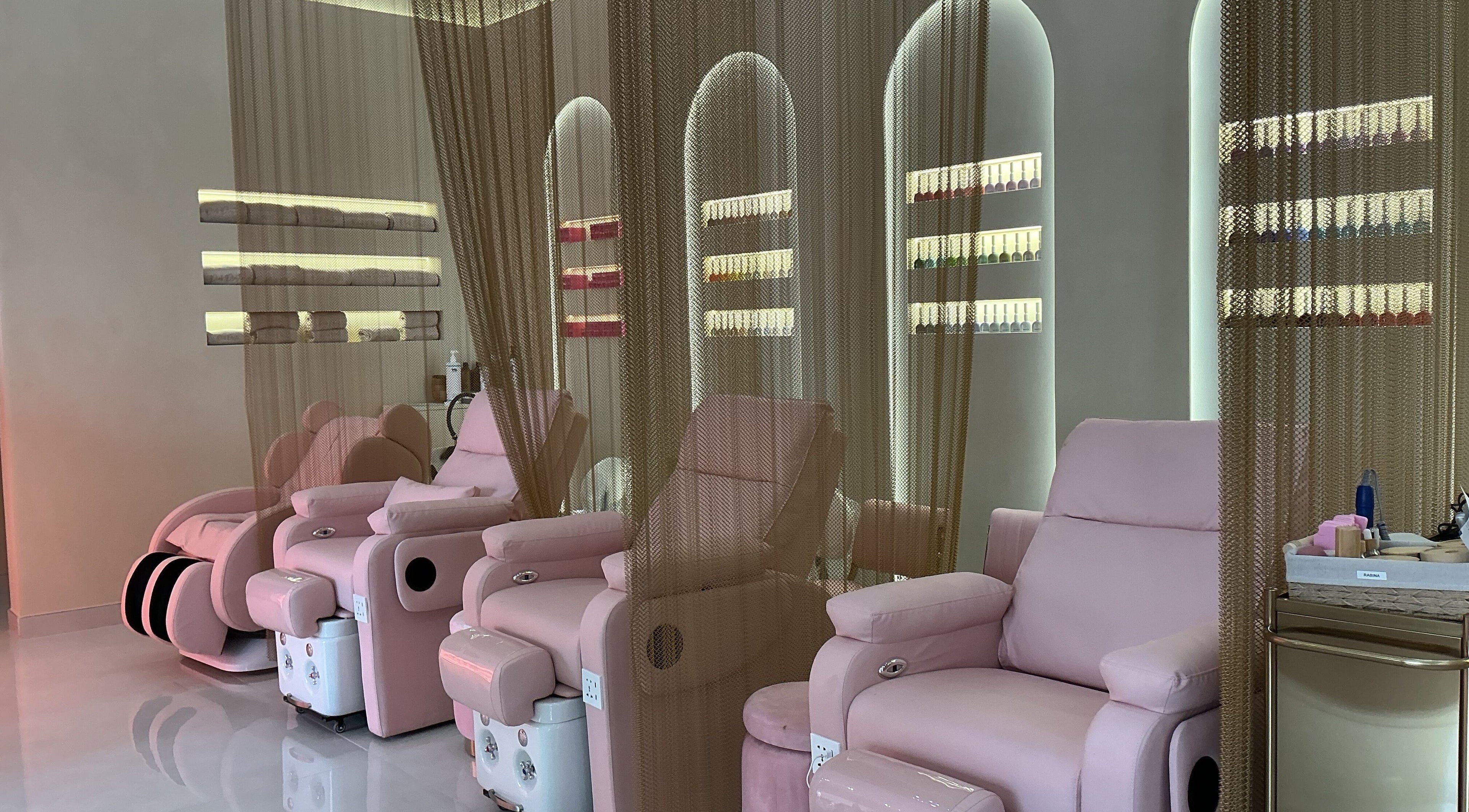 Relaxing lounge at Pink Plastic Women Salon Business Bay, Dubai, Dubai, AE with plush pink chairs and elegant decor.