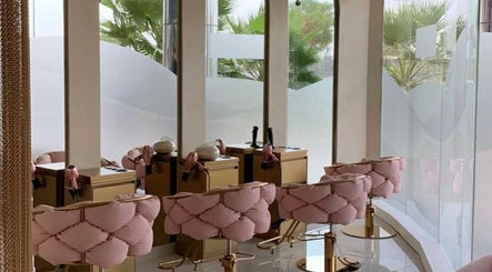 Elegant interior of Pink Plastic Women Salon Business Bay, Dubai, AE with plush pink chairs and large mirrors.