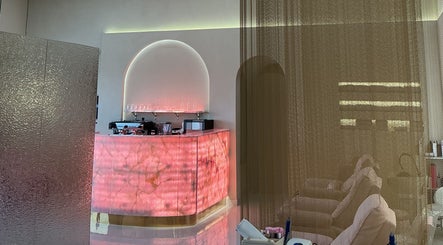 Elegant lounge area at Pink Plastic Women Salon Business Bay, Dubai, Dubai, AE with a glowing pink counter.