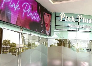 Entrance of HOME SERVICE - PINK PLASTIC SALON in Dubai, Dubai, AE with vibrant signage.