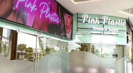 Entrance of HOME SERVICE - PINK PLASTIC SALON in Dubai, Dubai, AE with vibrant signage.