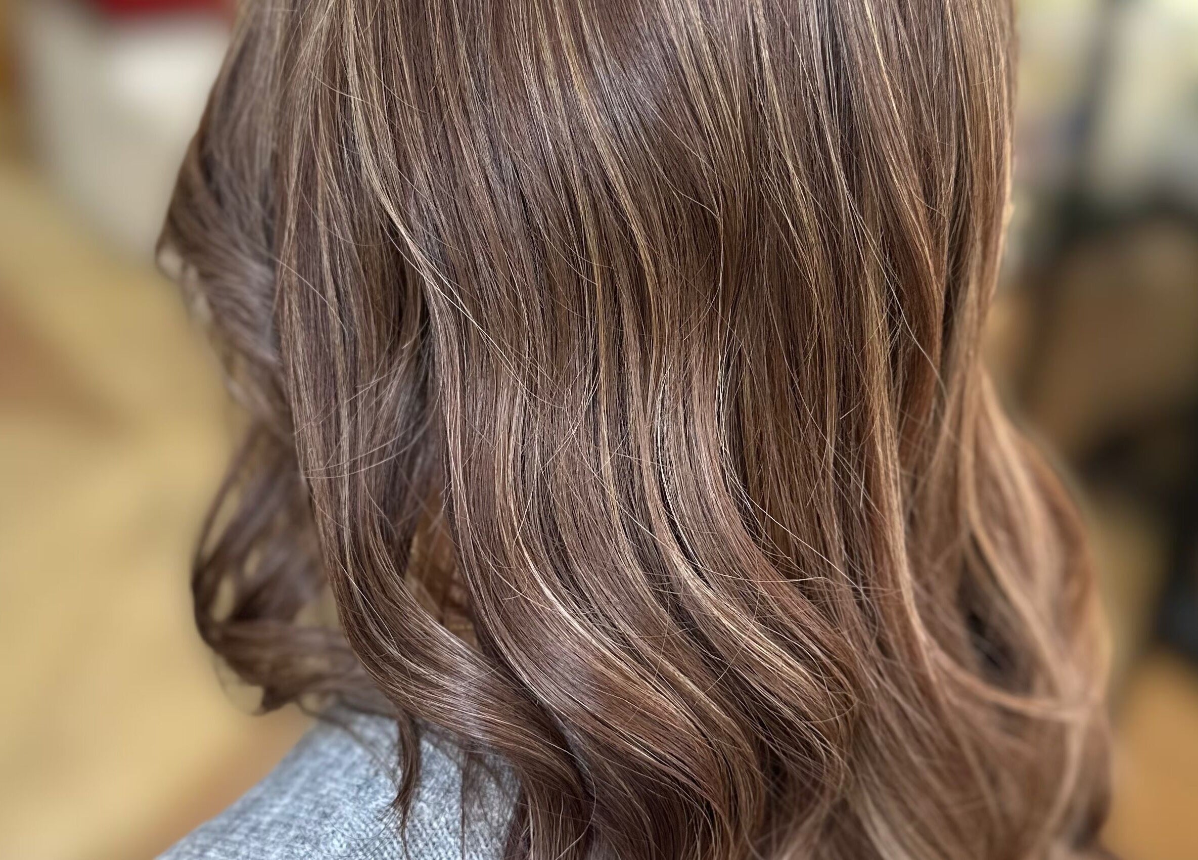 Close-up of silky brown hair with waves at Getty Space, London, England, GB, highlighting premium styling.