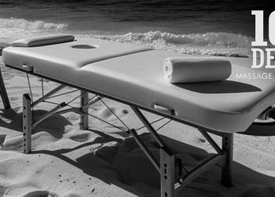 Massage table on sandy beach at 10-DER Massage Therapy, Christ Church, BB, offering relaxation by the ocean.
