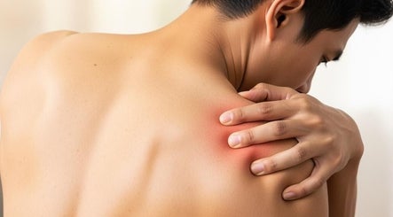 Person massaging sore shoulder at Advanced Muscle Therapy, Petaling Jaya, Selangor, MY.