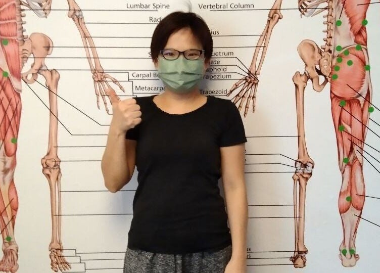 Client at Advanced Muscle Therapy, Petaling Jaya, Selangor, MY, with an anatomical muscle chart.