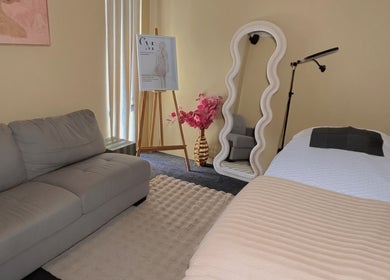 Chic spa room at Contour Me, Aubin Grove, Western Australia, AU showcasing elegant decor and a tranquil bed setup.