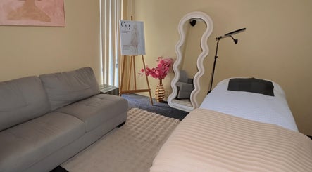 Chic spa room at Contour Me, Aubin Grove, Western Australia, AU showcasing elegant decor and a tranquil bed setup.