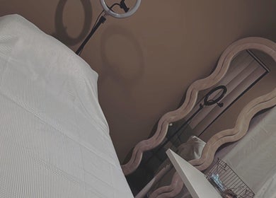 Relaxing treatment room at Contour Me, Aubin Grove, Western Australia, AU featuring a massage table and elegant mirror.