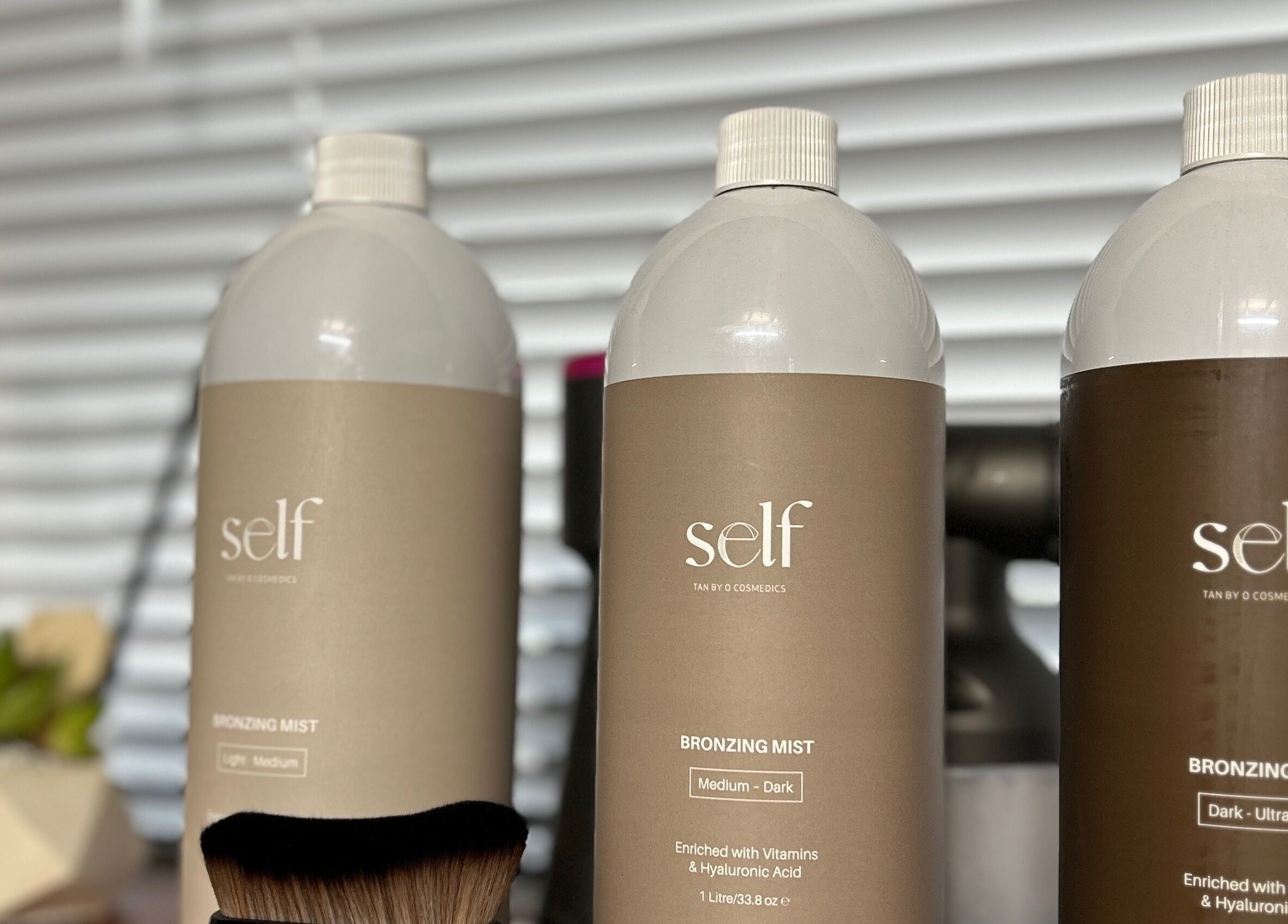 Self-tanning mist bottles at Oh Tan, Mundijong, Western Australia, AU, offering a flawless bronzed look.