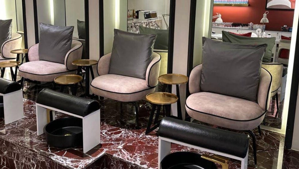 Elegant nail salon seating at Clue Salon, Riyadh, Riyadh Province, SA, featuring plush chairs and marble floors.