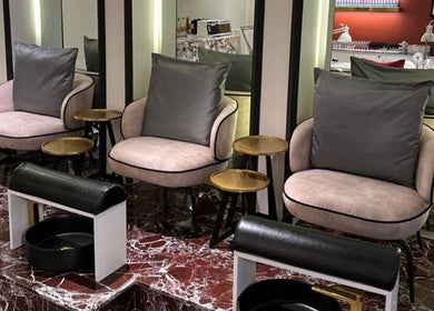 Elegant nail salon seating at Clue Salon, Riyadh, Riyadh Province, SA, featuring plush chairs and marble floors.