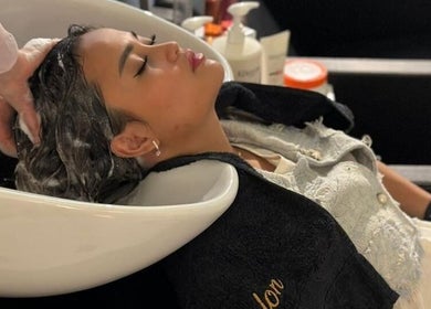 Relaxing hair wash at Clue Salon, Riyadh, Riyadh Province, SA, featuring gentle scalp massage.