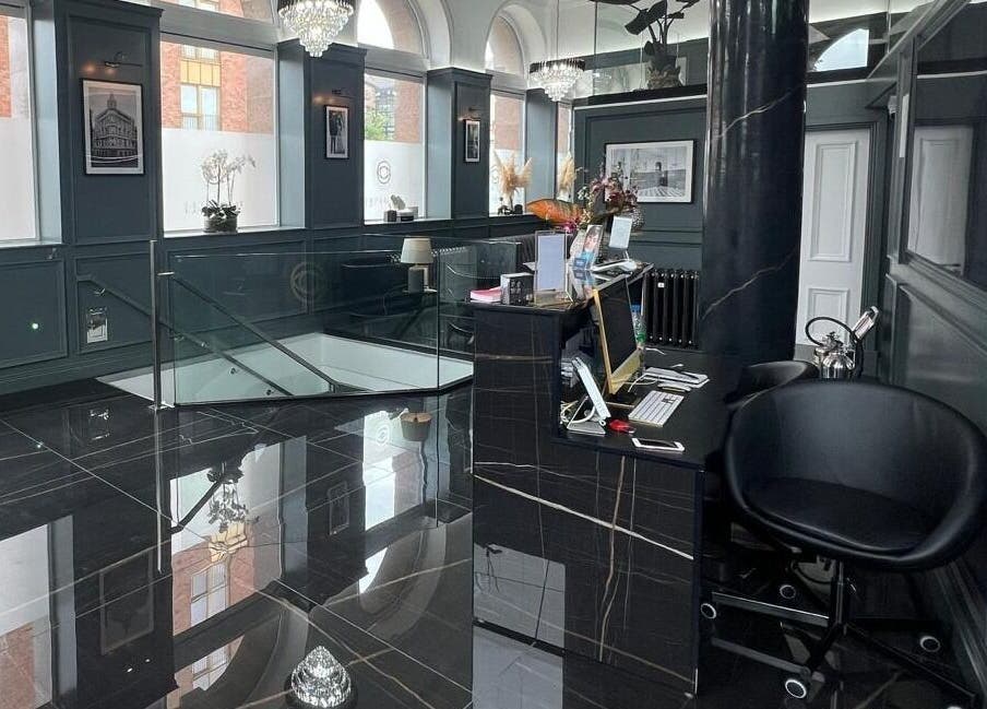 Elegant reception area at NEU® Cosmetic Clinic Glasgow, Glasgow, Scotland, GB with sleek black decor.