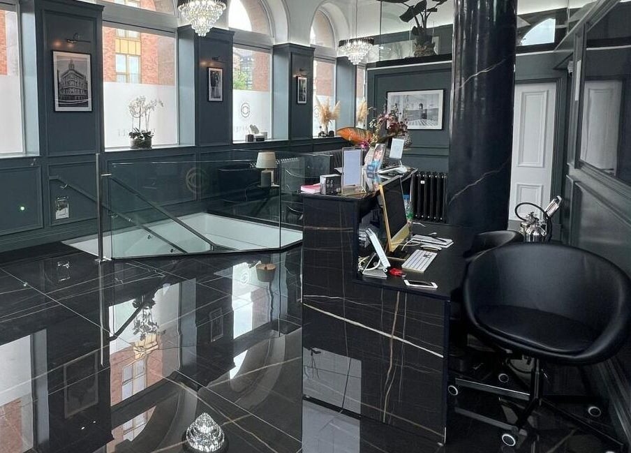 Elegant reception area at NEU® Cosmetic Clinic Glasgow, Glasgow, Scotland, GB with sleek black decor.