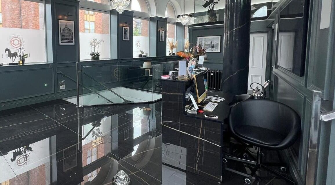 Elegant reception area at NEU® Cosmetic Clinic Glasgow, Glasgow, Scotland, GB with sleek black decor.