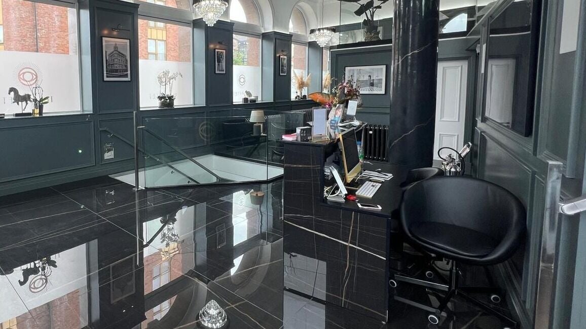 Elegant reception area at NEU® Cosmetic Clinic Glasgow, Glasgow, Scotland, GB with sleek black decor.