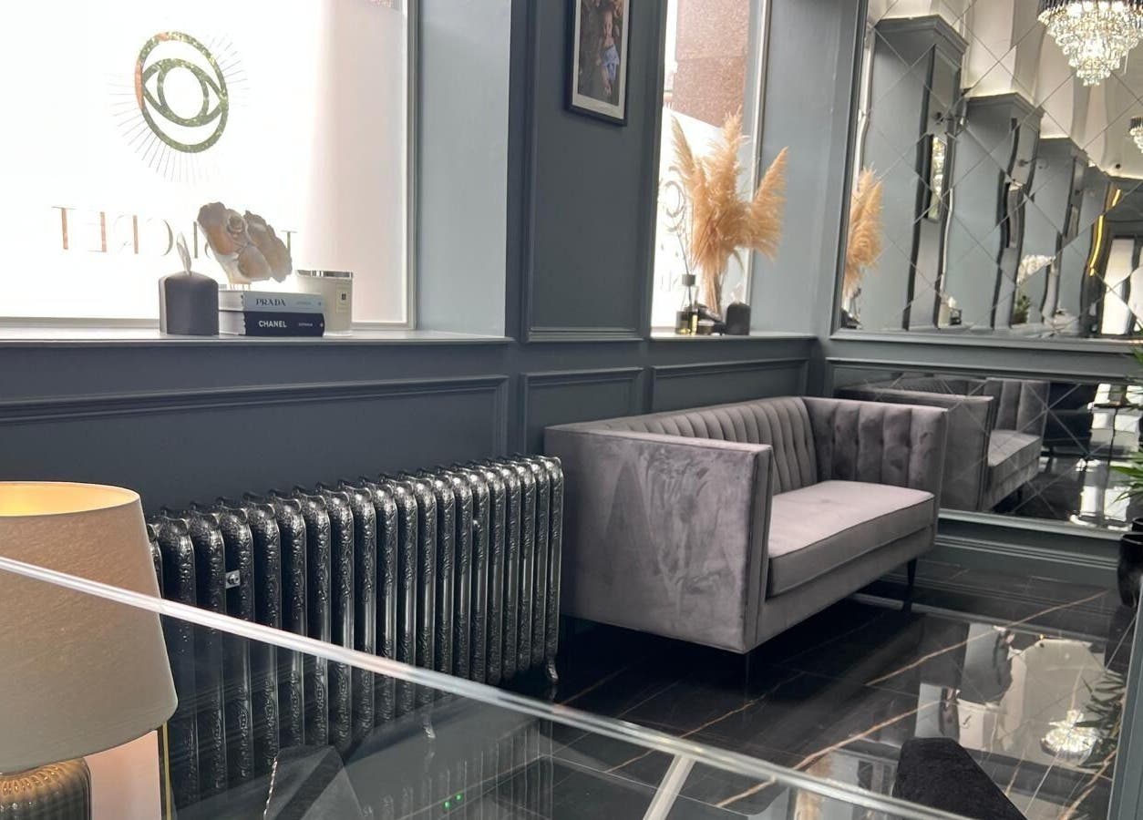 Elegant waiting area at NEU® Cosmetic Clinic Glasgow, featuring plush seating and designer decor in Glasgow, Scotland, GB.