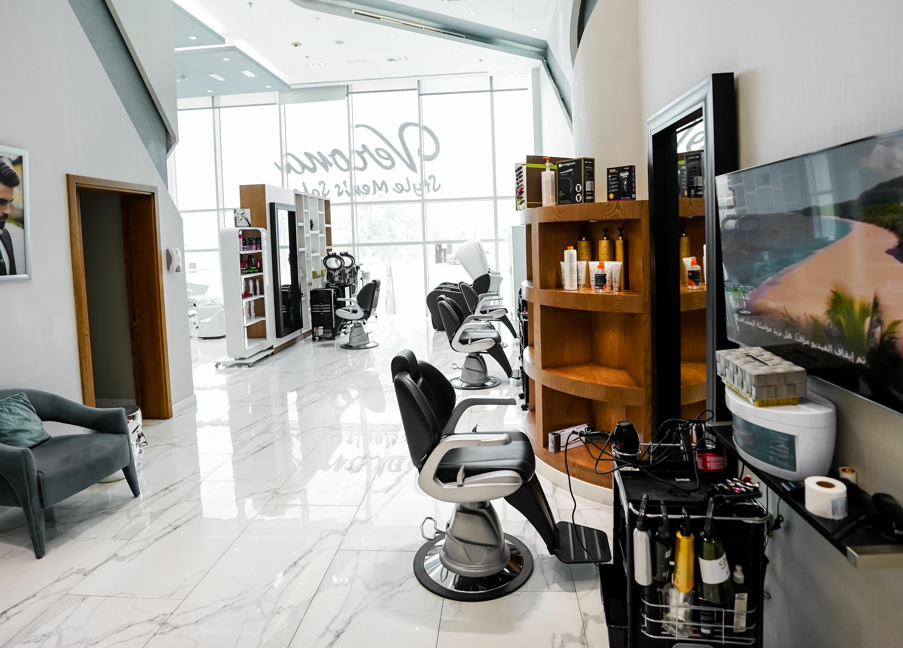 Modern interior of Verona Style Mens Salon in Abu Dhabi, AE with stylish chairs and grooming products.