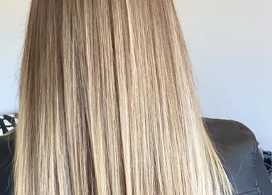 Blonde hair shines under light at Iliana’s Hair Salon, Chineham, England, GB.