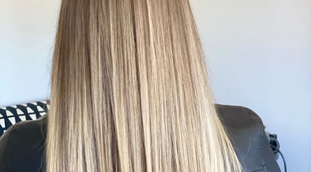 Blonde hair shines under light at Iliana’s Hair Salon, Chineham, England, GB.