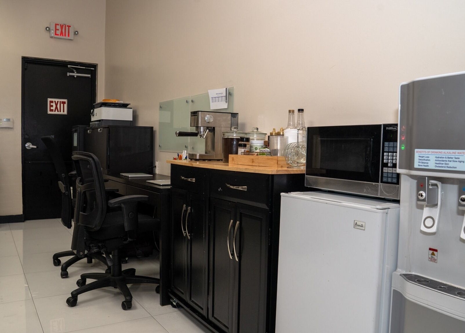 Modern workspace at RÊVE AESTHETICS by eyebrow studio in Doral, Florida, US, featuring a coffee machine.