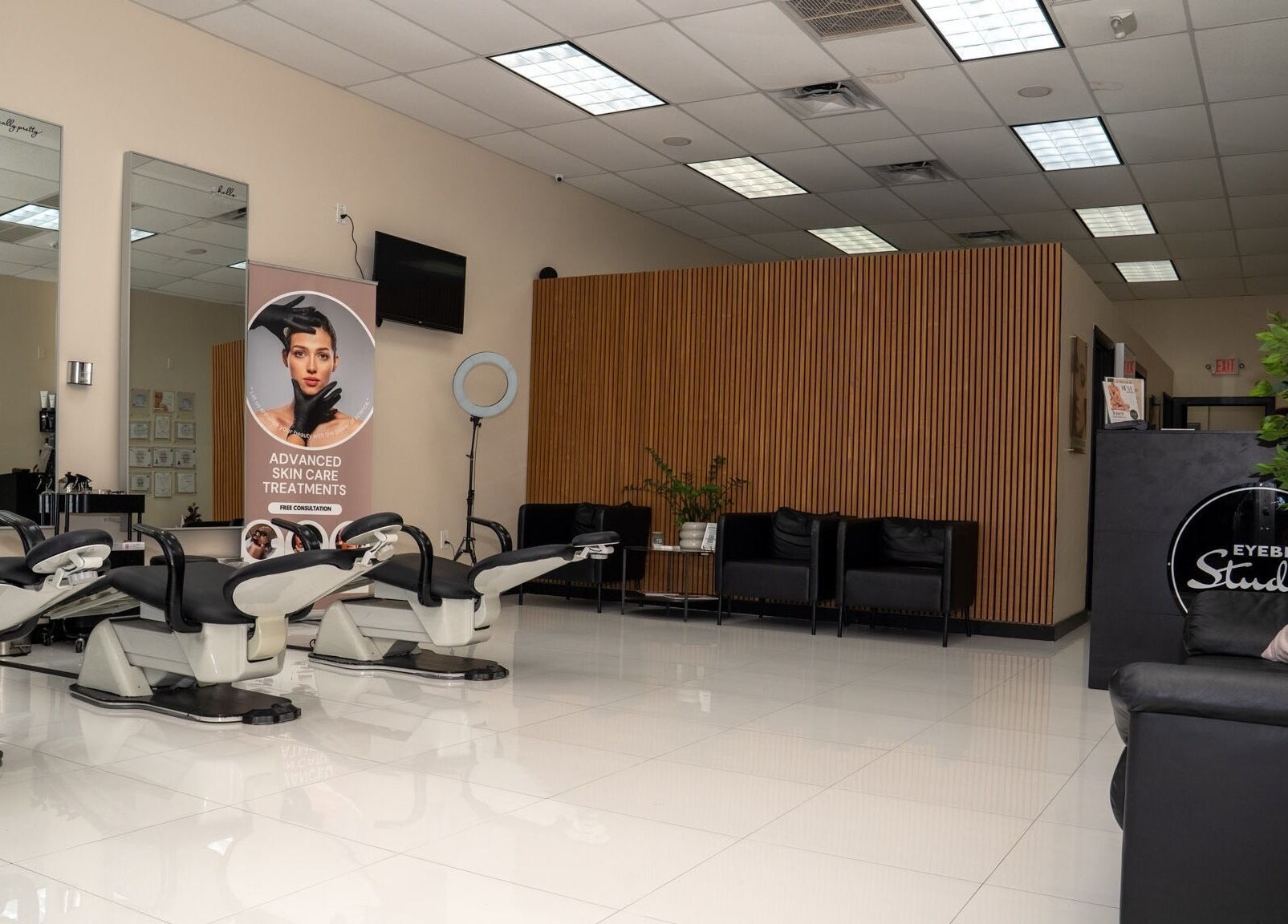 Interior of Rêve Aesthetics By Eyebrow Studio in Doral, Florida, US, featuring sleek styling chairs and modern decor.