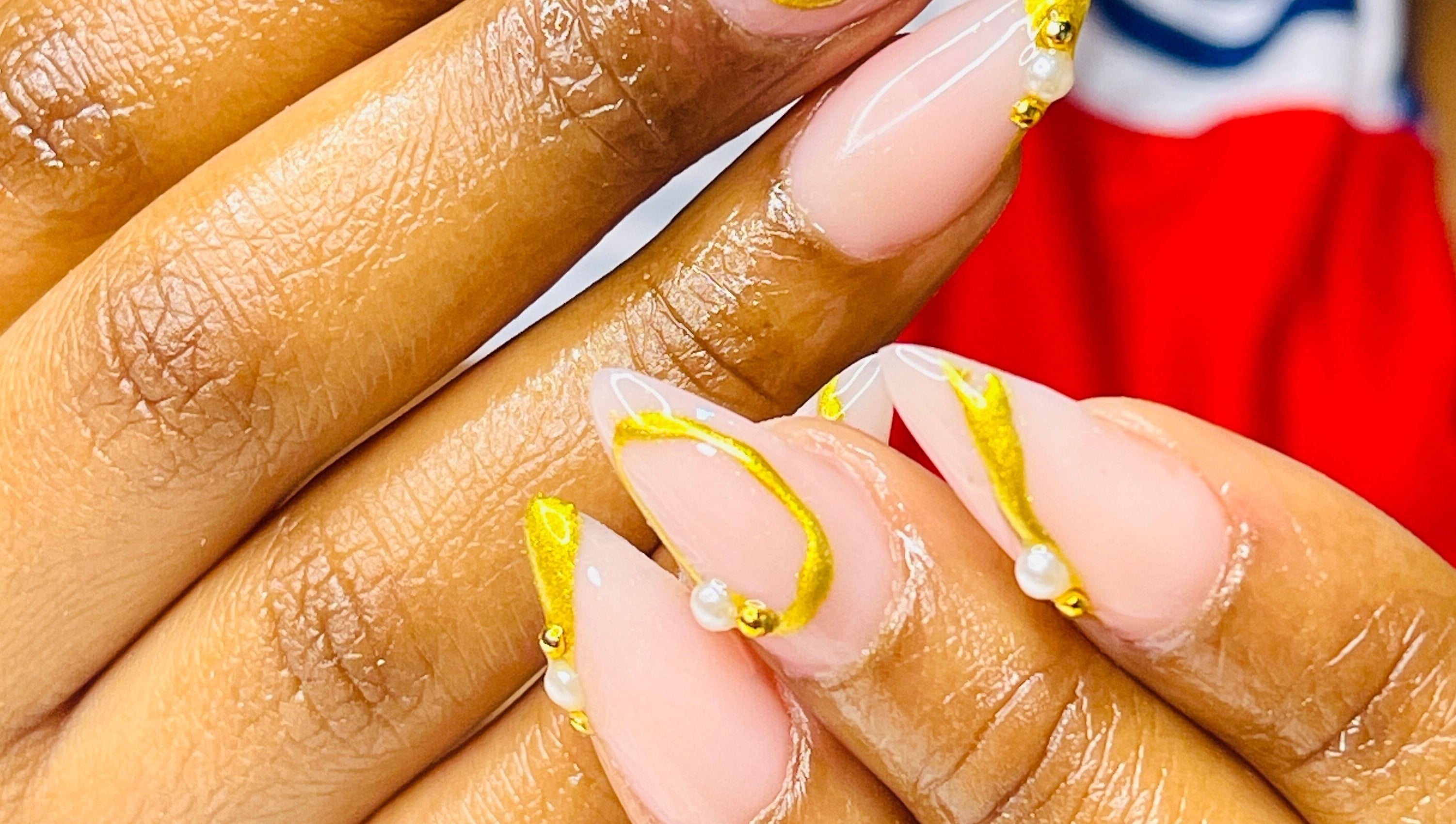 Close-up of intricate gold nail art at African Girls Hair, Roodepoort, Gauteng, ZA.
