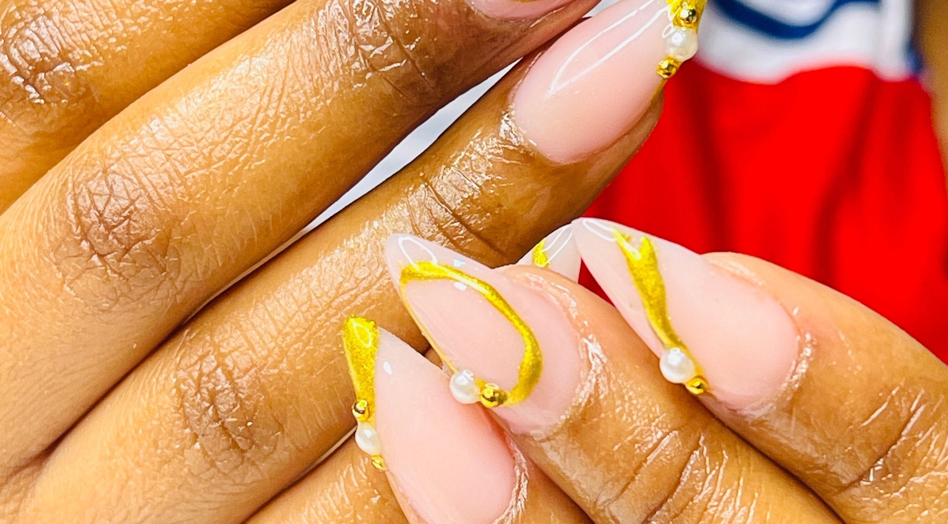 Close-up of intricate gold nail art at African Girls Hair, Roodepoort, Gauteng, ZA.