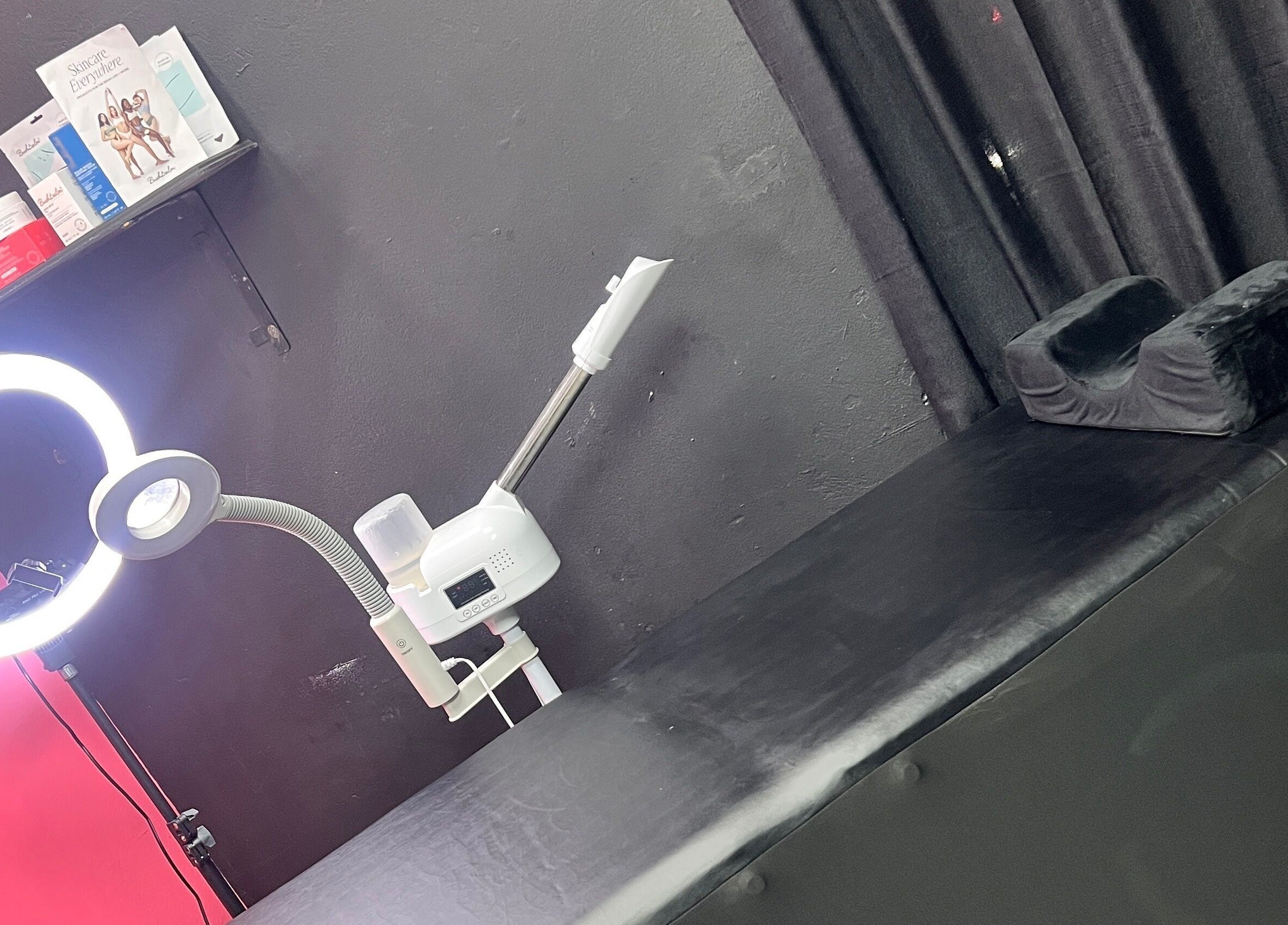 Treatment room at Tsparadise in San Juan, San Juan-laventille Regional Corporation, TT with black bed and ring light.