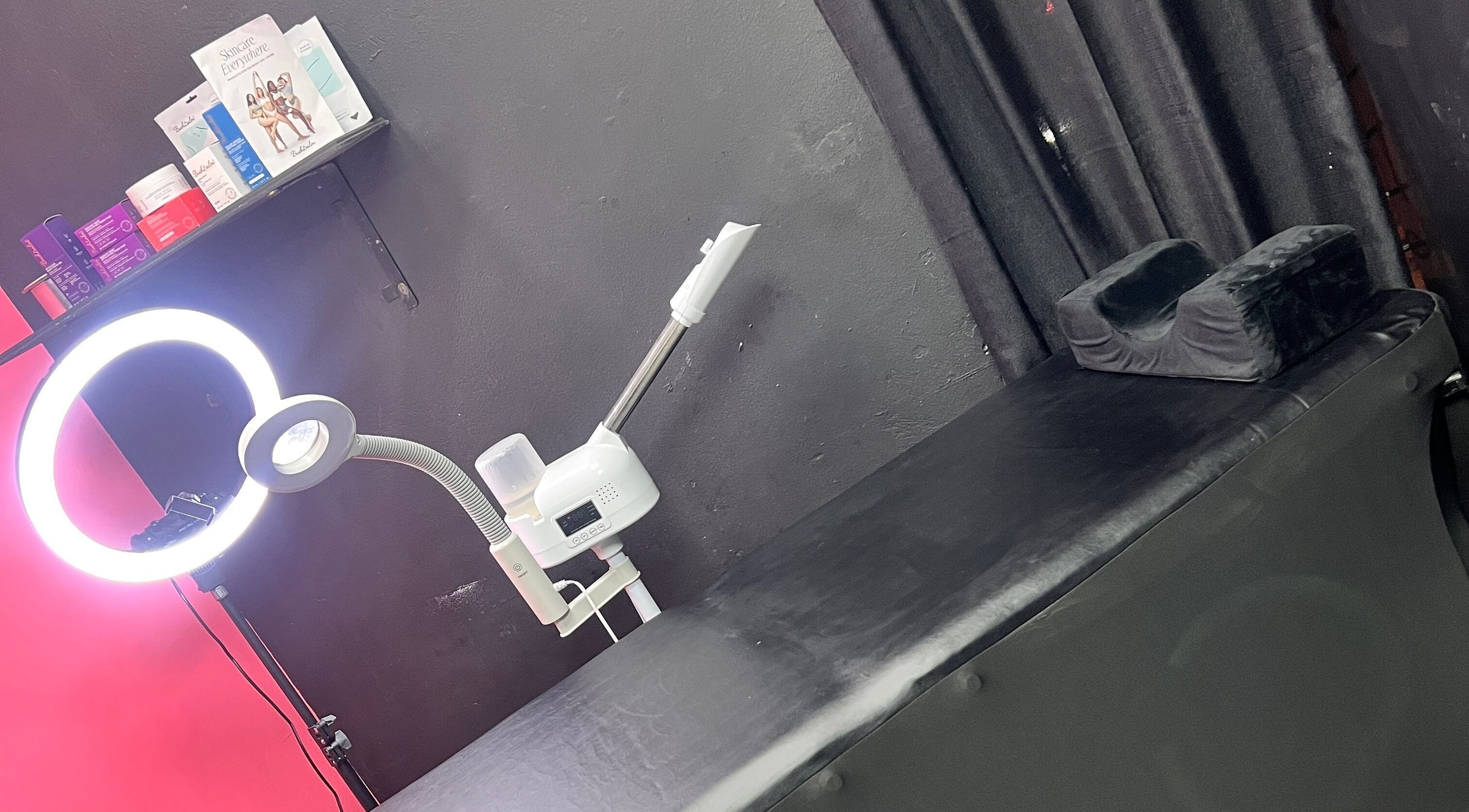 Treatment room at Tsparadise in San Juan, San Juan-laventille Regional Corporation, TT with black bed and ring light.