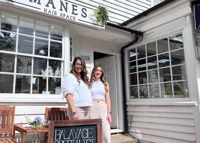 Exterior of Manes Hair Space in Tenterden, England, GB, showcasing welcoming entrance and smiling staff.
