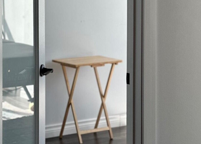 Minimalist wooden table near frosted door at Soo Healing Studio, Toronto, Ontario, CA.
