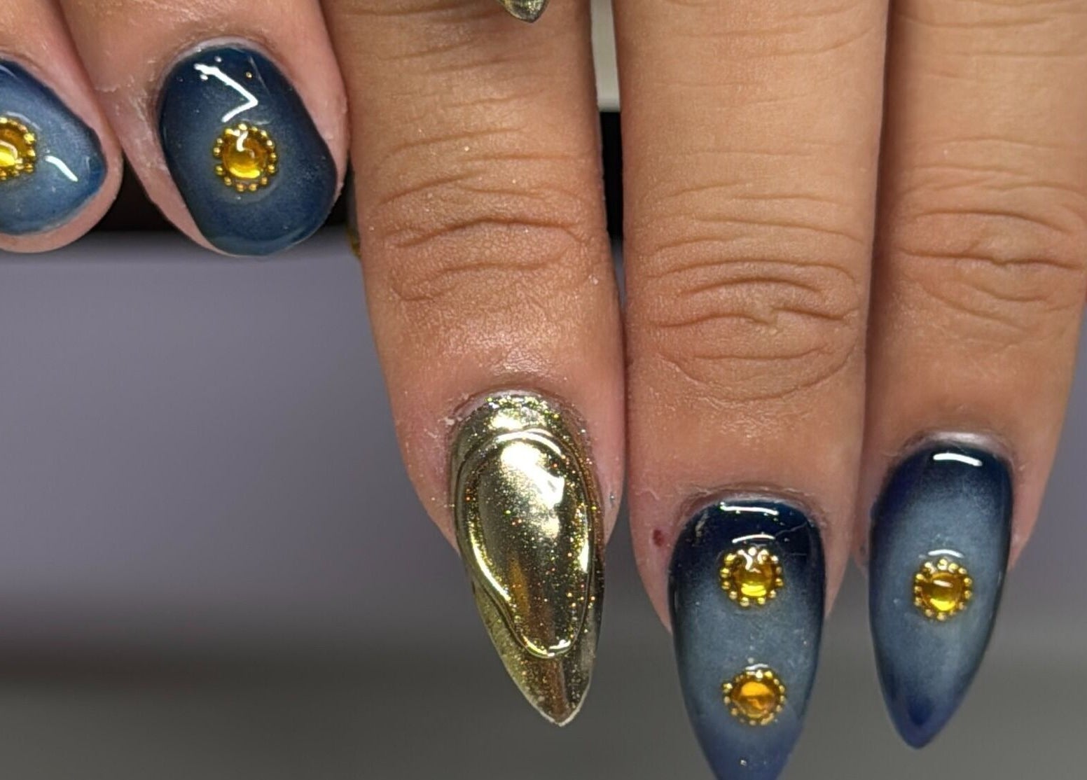 Nail art with gold accents at Nails by Kelly, San Diego, California, US, showcasing intricate designs.