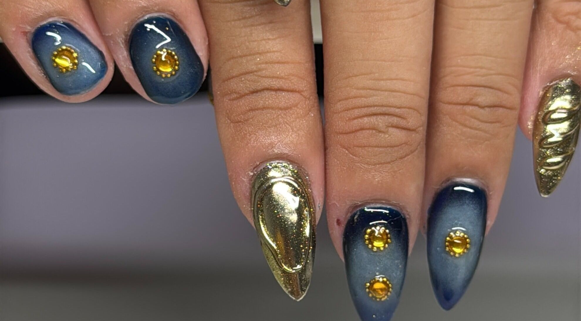 Nail art with gold accents at Nails by Kelly, San Diego, California, US, showcasing intricate designs.
