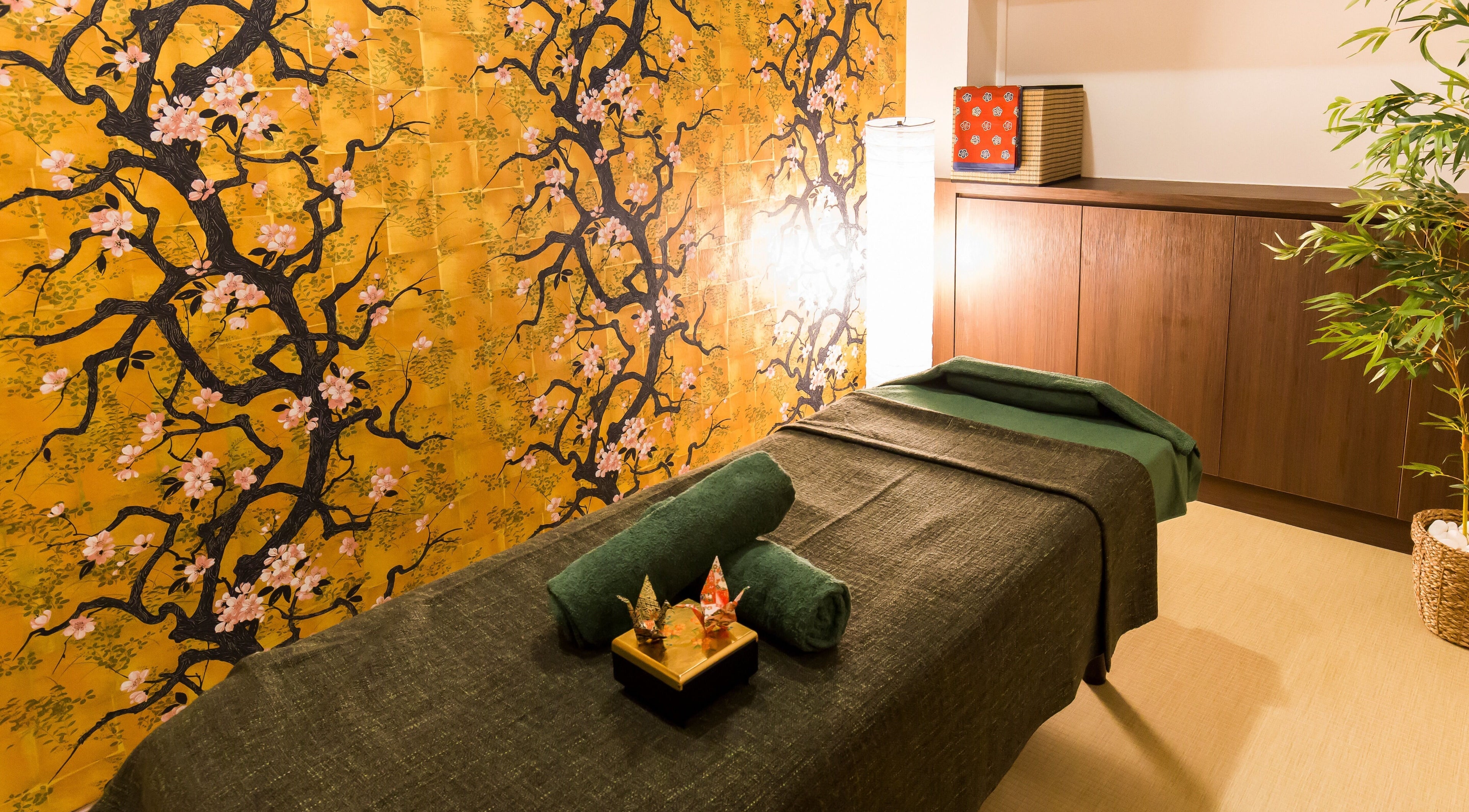 Serene massage room with cherry blossom decor at Atelier Kogao Clarke Quay, Singapore, Singapore, SG.