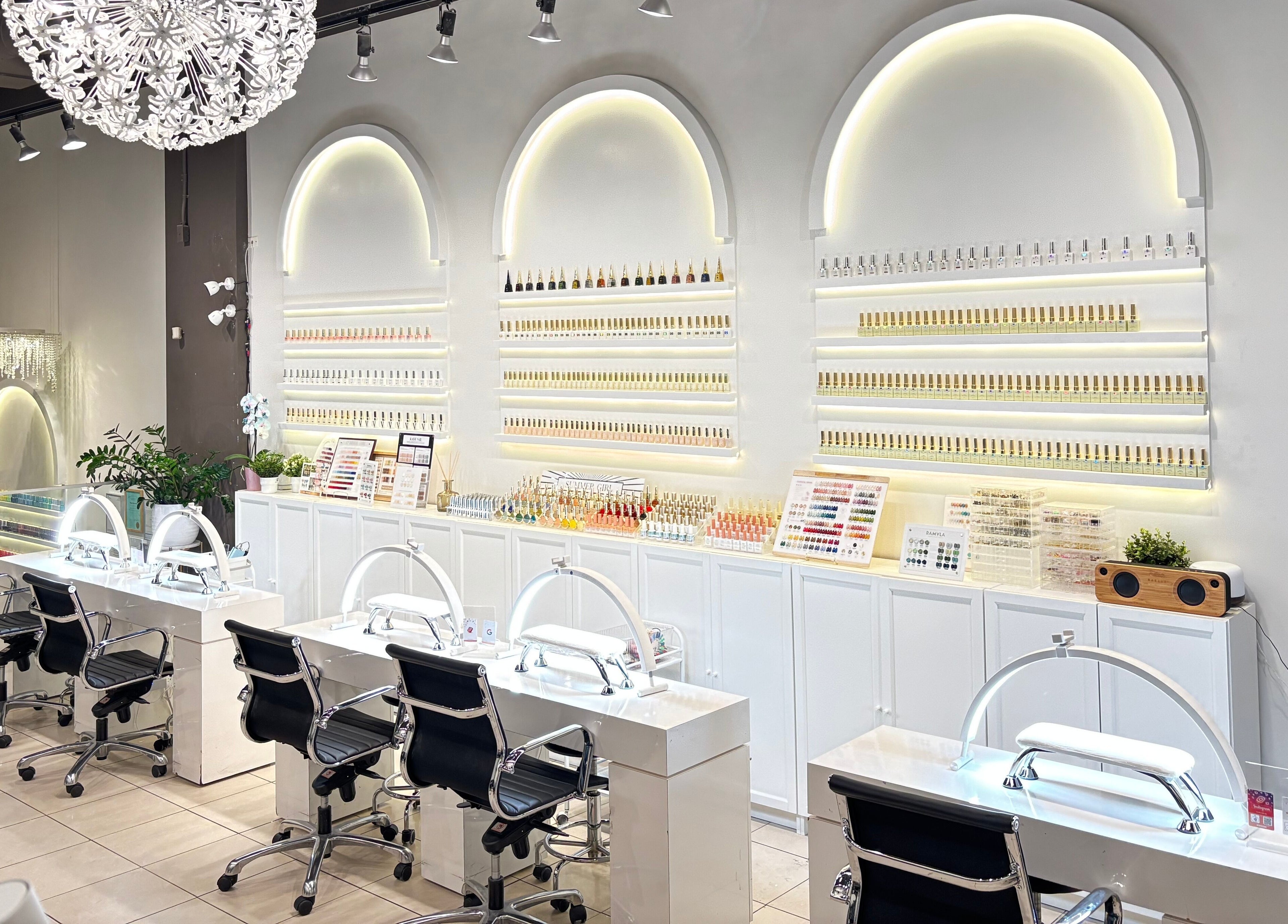 Sleek interior of Robson Nails & Spa in Vancouver, British Columbia, CA showcasing nail stations and polish displays.