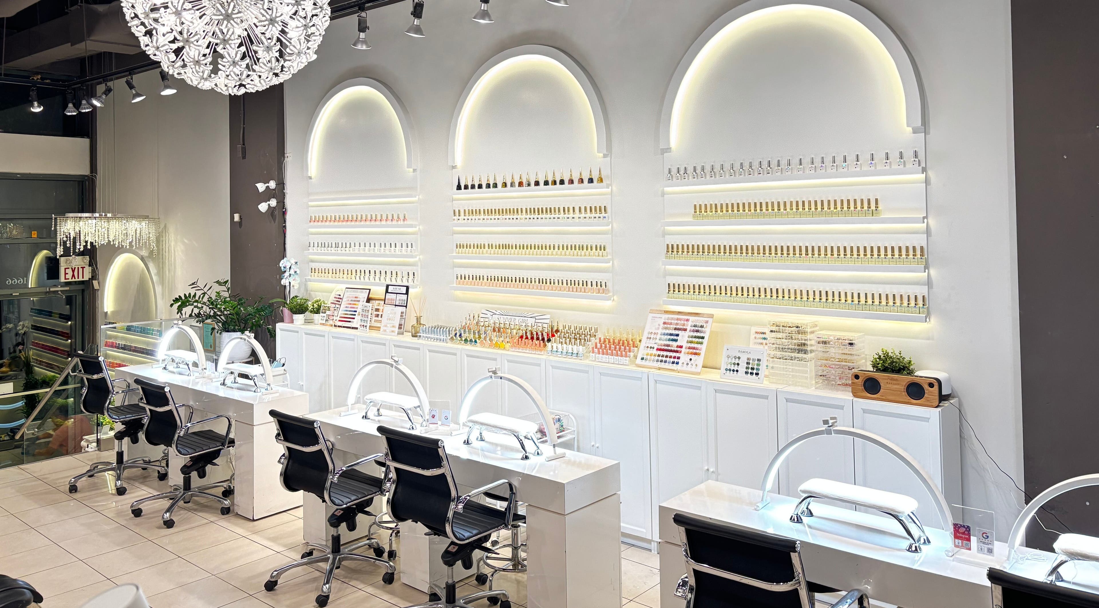 Sleek interior of Robson Nails & Spa in Vancouver, British Columbia, CA showcasing nail stations and polish displays.