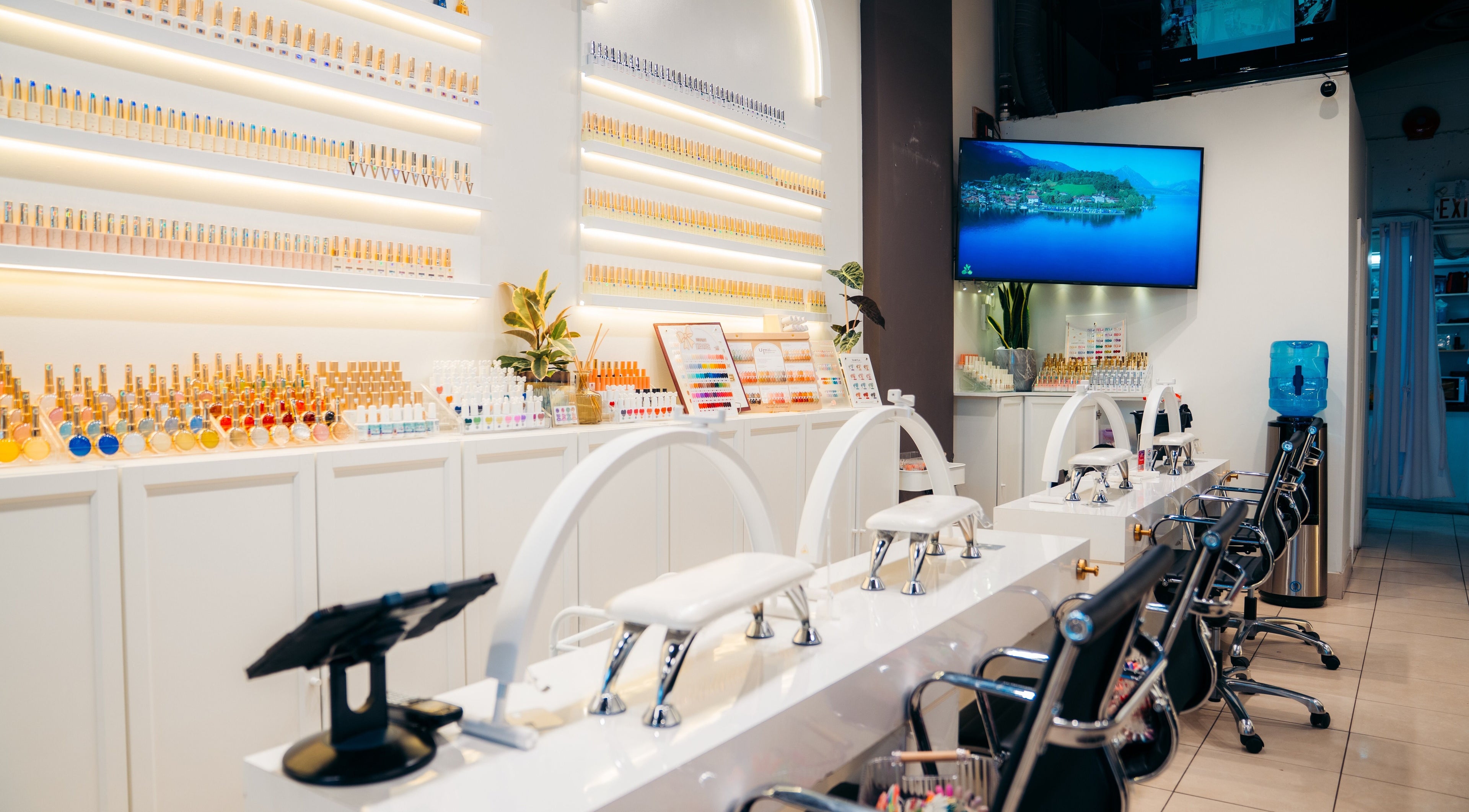 Modern nail bar at Robson Nails & Spa, Vancouver, British Columbia, CA showcasing vibrant polishes and stylish seating.