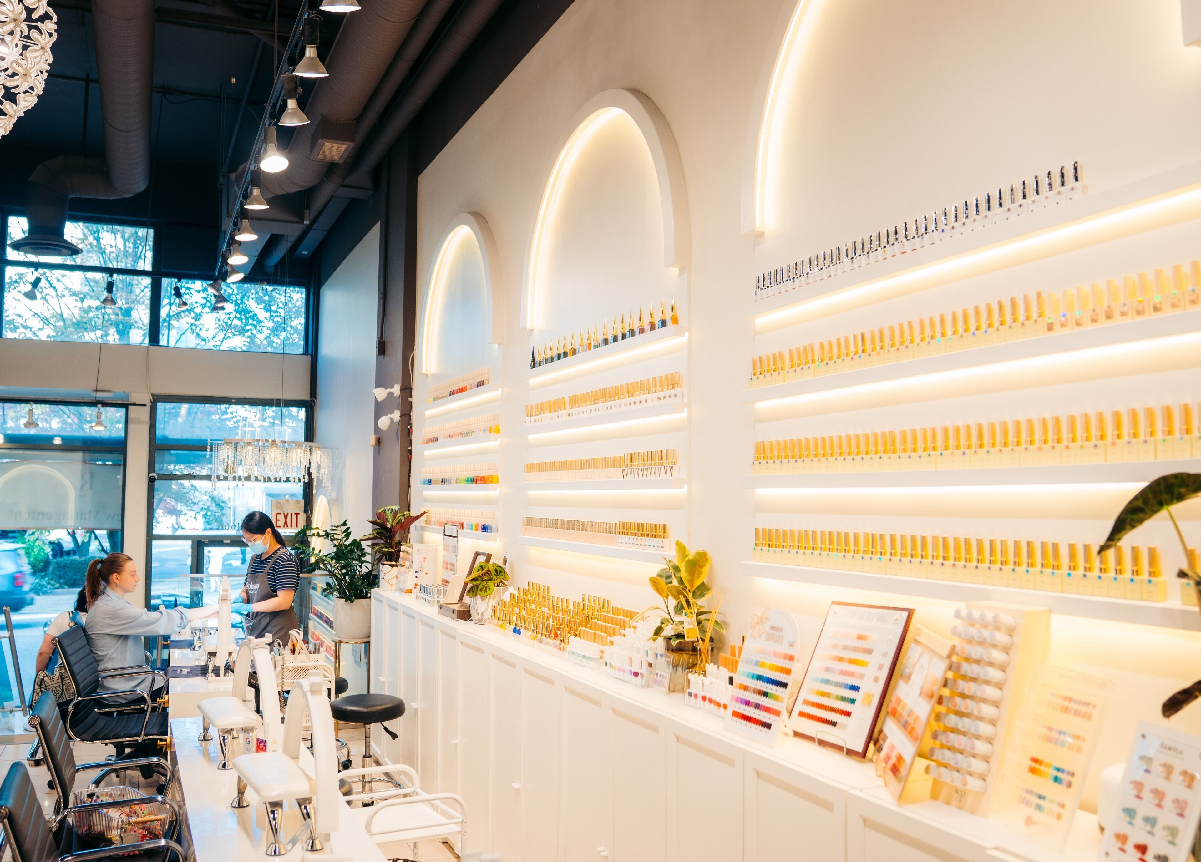 Interior of Robson Nails & Spa, Vancouver, BC, CA, showcasing stylish nail polish displays and seating area.