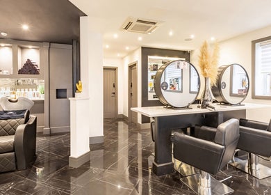 Elegant interior of Maria Charles Hair Crawley, located in Crawley, England, GB featuring modern styling stations.