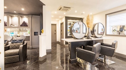Elegant interior of Maria Charles Hair Crawley, located in Crawley, England, GB featuring modern styling stations.