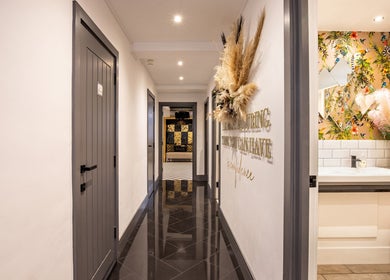 Elegant hallway at Maria Charles Hair Crawley, featuring modern decor and floral accents in Crawley, England, GB.