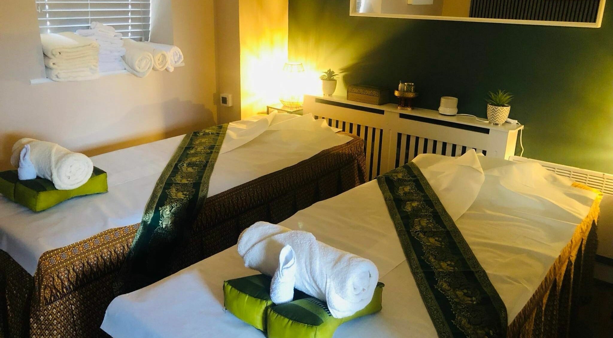 Relaxing massage room at Thai House Spa Old Town, Swindon, England, GB with towels and soothing decor.