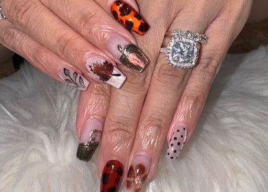 Close-up of detailed autumn-themed nail art at Bee Sassy Nails, Rocklin, California, US.