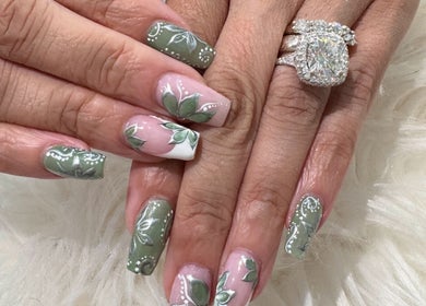 Elegant floral nail art at Bee Sassy Nails, Rocklin, California, US, showcasing intricate green designs.