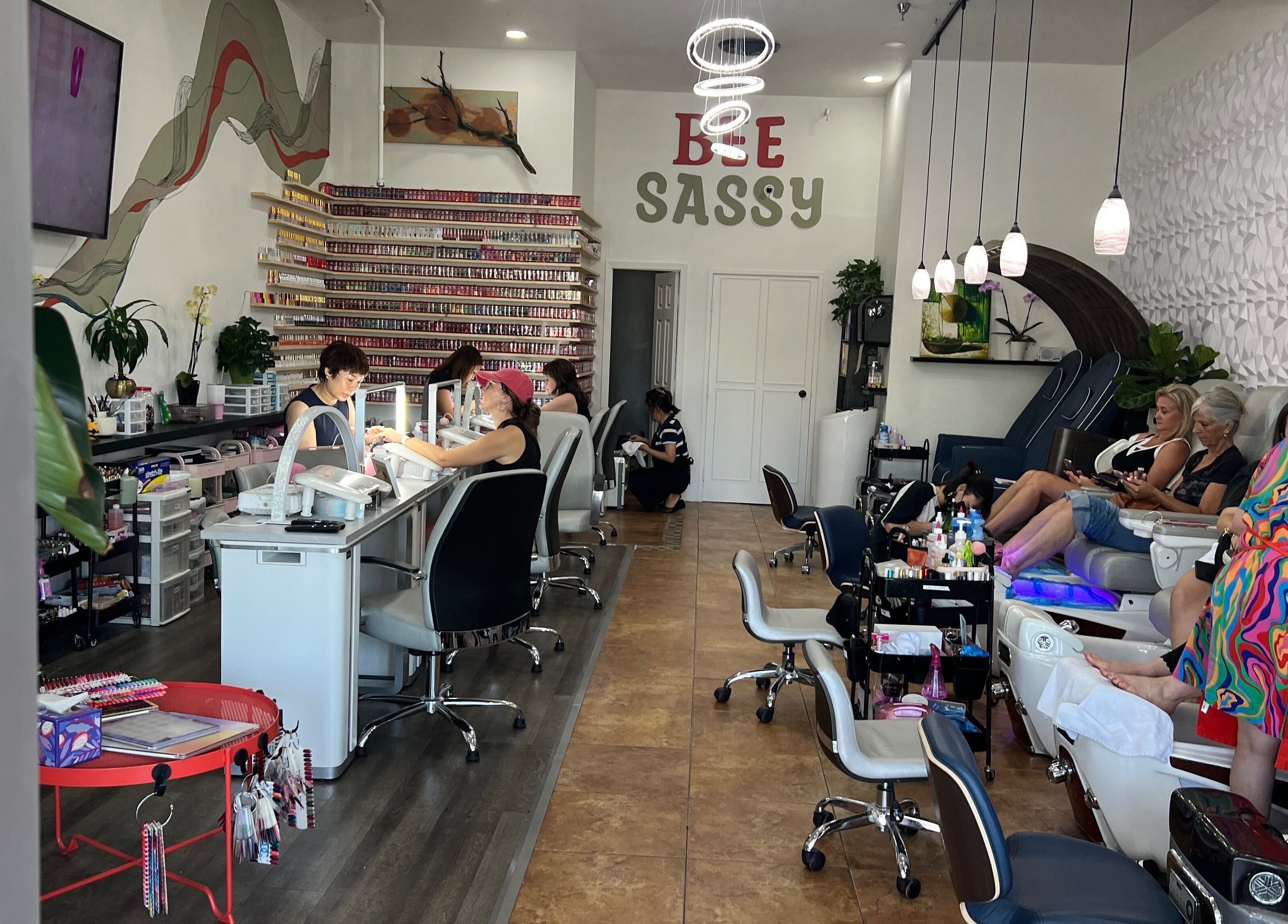 Interior of Bee Sassy Nails in Rocklin, California, US, showcasing nail stations and modern decor.